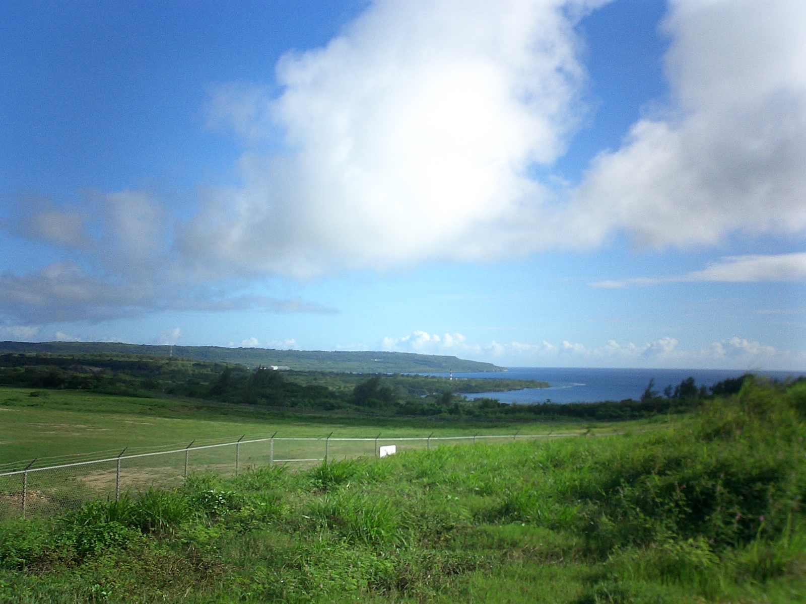 A green coastal landscape overlooking Sunharon Bay on Tinian