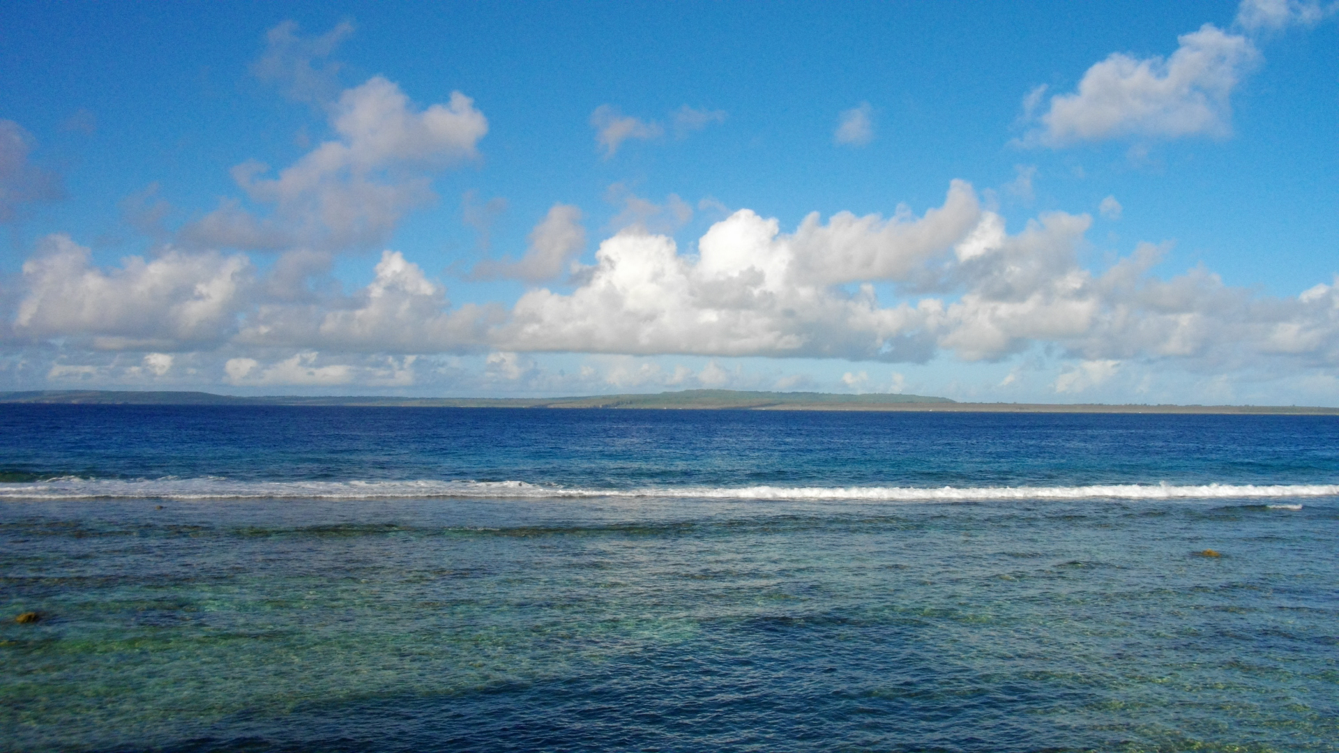 A wide view of Tinian's coastline and blue Pacific water